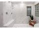 Luxurious shower featuring marble walls, mosaic tile floor and decorative glass block window at 8219 S Pecan Grove Cir, Tempe, AZ 85284
