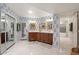 The bathroom features double vanities, white marble floors, and patterned wallpaper at 8219 S Pecan Grove Cir, Tempe, AZ 85284