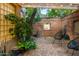 Private courtyard featuring brick walls, pergola with string lights, seating, and water feature at 8219 S Pecan Grove Cir, Tempe, AZ 85284