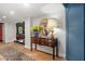 Welcoming entryway with hardwood floors, a decorative table, and a round mirror at 8219 S Pecan Grove Cir, Tempe, AZ 85284