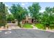 Beautiful home featuring manicured landscaping, a brick driveway and accents, and mature trees providing natural shade at 8219 S Pecan Grove Cir, Tempe, AZ 85284