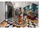 Grand foyer with a checkered floor, striking decor, and an arched doorway leading to the dining room at 8219 S Pecan Grove Cir, Tempe, AZ 85284