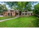 Stunning home with brick and stucco, a well-kept lawn, and a charming entryway, all shaded by mature trees at 8219 S Pecan Grove Cir, Tempe, AZ 85284