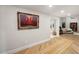 Hallway with wood floors, elegant painting, and views of the bedroom and bath at 8219 S Pecan Grove Cir, Tempe, AZ 85284