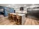 The chef's kitchen features a large center island with seating and stainless steel appliances at 8219 S Pecan Grove Cir, Tempe, AZ 85284