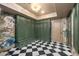 Laundry room with custom green cabinets and stylish black and white floors at 8219 S Pecan Grove Cir, Tempe, AZ 85284