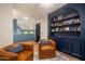 Cozy living room with built-in shelves, leather chairs, and natural light at 8219 S Pecan Grove Cir, Tempe, AZ 85284