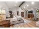 Spacious primary bedroom with beamed ceiling, hardwood floors, fireplace and sitting area at 8219 S Pecan Grove Cir, Tempe, AZ 85284