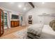 Bright primary bedroom showcases hardwood floors, beamed ceiling, fireplace and picture windows at 8219 S Pecan Grove Cir, Tempe, AZ 85284
