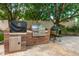 Outdoor kitchen with built-in grill, brick surround, stainless steel features, and a Big Green Egg at 8219 S Pecan Grove Cir, Tempe, AZ 85284