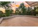 Expansive outdoor patio with iron railings, offering serene views of the lush backyard and colorful sky at 8219 S Pecan Grove Cir, Tempe, AZ 85284