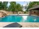 Backyard pool featuring a rock waterfall, poolside seating, and a cozy outdoor fireplace at 8219 S Pecan Grove Cir, Tempe, AZ 85284