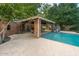 Outdoor pool area featuring a covered patio, outdoor kitchen, and plenty of space for relaxation at 8219 S Pecan Grove Cir, Tempe, AZ 85284