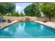 Large backyard pool with rock waterfall slide, mature trees, and ample patio space at 8219 S Pecan Grove Cir, Tempe, AZ 85284