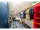 Organized walk-in closet with clothes, hats, and toys, offering ample storage space at 8219 S Pecan Grove Cir, Tempe, AZ 85284