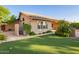 The backyard has a putting green and view of the home's exterior at 8402 W Rosemonte Dr, Peoria, AZ 85382