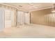 Light-filled bedroom featuring carpet, ceiling fan, and organized walk-in closet at 8402 W Rosemonte Dr, Peoria, AZ 85382
