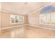 Bright bedroom with natural light, tiled floors, and arched window at 8402 W Rosemonte Dr, Peoria, AZ 85382