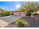 Single-story home showcasing a three-car garage, desert landscape and well-kept curb appeal at 8402 W Rosemonte Dr, Peoria, AZ 85382