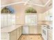 Bright kitchen features tiled countertops, white appliances, and ample cabinet space at 8402 W Rosemonte Dr, Peoria, AZ 85382