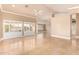 A generous living space featuring plantation shutters, tiled floors, and arched doorways at 8402 W Rosemonte Dr, Peoria, AZ 85382