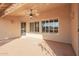 Covered outdoor patio with a ceiling fan and large windows at 8402 W Rosemonte Dr, Peoria, AZ 85382