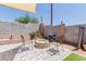 Charming backyard boasts a cozy firepit, with four chairs, and gravel groundcover at 8622 W Shaw Butte Dr, Peoria, AZ 85345