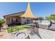 Spacious backyard features a hot tub, firepit, and picnic table with a shaded area, perfect for relaxing and entertaining at 8622 W Shaw Butte Dr, Peoria, AZ 85345