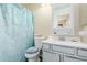 Cozy bathroom featuring a toilet with soft seat, polka dot shower curtain and vanity with a mirror at 8622 W Shaw Butte Dr, Peoria, AZ 85345