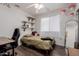 Bedroom featuring laminate floors, floating shelves, and fun mushroom decor at 8622 W Shaw Butte Dr, Peoria, AZ 85345