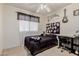 This bedroom is decorated with dark colors, a music themed sign, and a ceiling fan at 8622 W Shaw Butte Dr, Peoria, AZ 85345