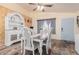 Charming dining room with decorative hutch, rustic wood floors, and a pastel blue door at 8622 W Shaw Butte Dr, Peoria, AZ 85345