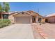 Charming single-story home with desert landscaping, two-car garage and covered entryway at 8622 W Shaw Butte Dr, Peoria, AZ 85345