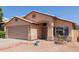 Inviting home exterior featuring a well-manicured lawn, desert landscaping, and a spacious two-car garage at 8622 W Shaw Butte Dr, Peoria, AZ 85345