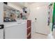 Functional laundry room features a white washer and dryer, shelves and storage, plus access to outside at 8622 W Shaw Butte Dr, Peoria, AZ 85345