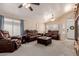 Spacious living room with plush leather seating, ceiling fans, and abundant natural light at 8622 W Shaw Butte Dr, Peoria, AZ 85345