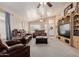 Cozy living area featuring leather furniture, vaulted ceiling, and a decorative entertainment center at 8622 W Shaw Butte Dr, Peoria, AZ 85345
