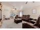 Spacious living room with plush leather seating, ceiling fans, and abundant natural light at 8622 W Shaw Butte Dr, Peoria, AZ 85345