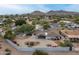 Wide aerial shot displays the home with landscaped yard and community at 9039 N Concho Ln, Phoenix, AZ 85028