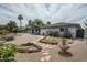Spacious backyard with desert landscaping and a covered patio at 9039 N Concho Ln, Phoenix, AZ 85028