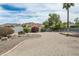 Expansive gravel backyard with mature trees and colorful shrubs, bordered by a block wall for privacy at 9039 N Concho Ln, Phoenix, AZ 85028