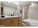 Well-lit bathroom featuring tile flooring, tiled shower-bath and vanity at 9039 N Concho Ln, Phoenix, AZ 85028
