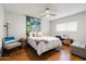 Comfortable bedroom with wood floors, decorative accents and a bright window at 9039 N Concho Ln, Phoenix, AZ 85028