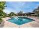 Community pool and seating area with mature trees and mountain views at 9039 N Concho Ln, Phoenix, AZ 85028