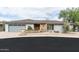 Inviting single-story home featuring a stone facade, xeriscaping, and a two-car garage at 9039 N Concho Ln, Phoenix, AZ 85028