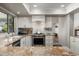 Cozy kitchen with stainless steel oven, granite countertops, and white cabinetry at 9039 N Concho Ln, Phoenix, AZ 85028