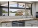 View from the kitchen sink with a view of manicured garden and mountain background at 9039 N Concho Ln, Phoenix, AZ 85028