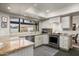 Bright kitchen featuring stainless steel appliances, white cabinetry, and stone countertops at 9039 N Concho Ln, Phoenix, AZ 85028
