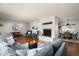 Spacious living room featuring a fireplace, hardwood floors, and an open layout to the dining area at 9039 N Concho Ln, Phoenix, AZ 85028