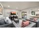 Open concept living room with a modern gray sofa, stylish decor, and access to the outdoor patio at 9039 N Concho Ln, Phoenix, AZ 85028